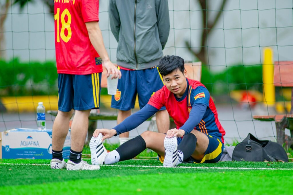 Young football players stretching before a game in Hanoi, Vietnam.